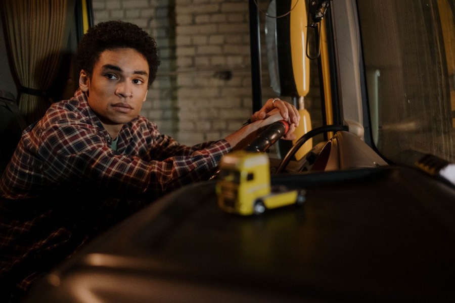 A driver at the wheel of their truck